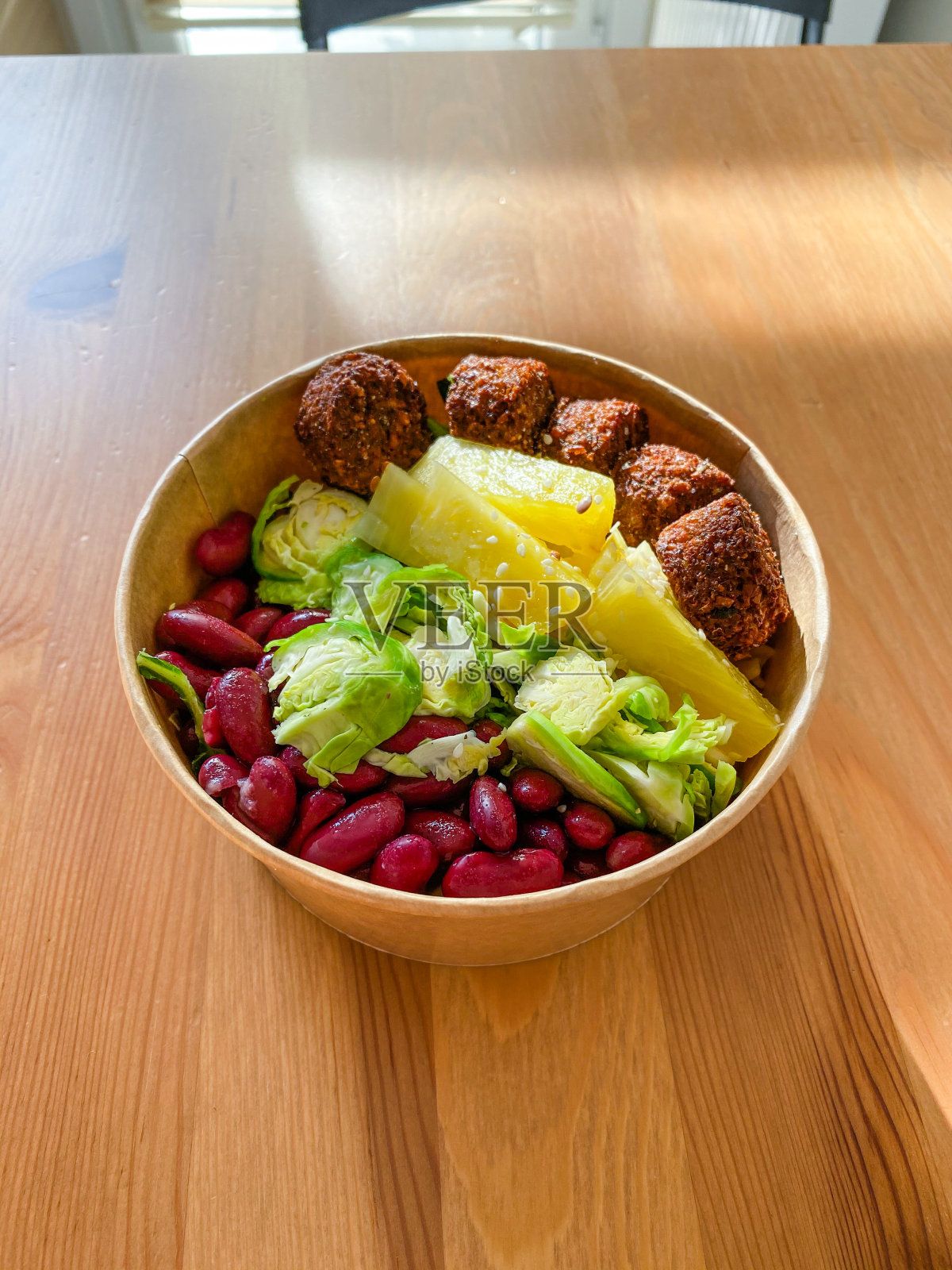 健康食物碗，含有沙拉三明治，菠萝，墨西哥红芸豆和抱子甘蓝，塑料碗/盒子或容器包装。照片摄影图片