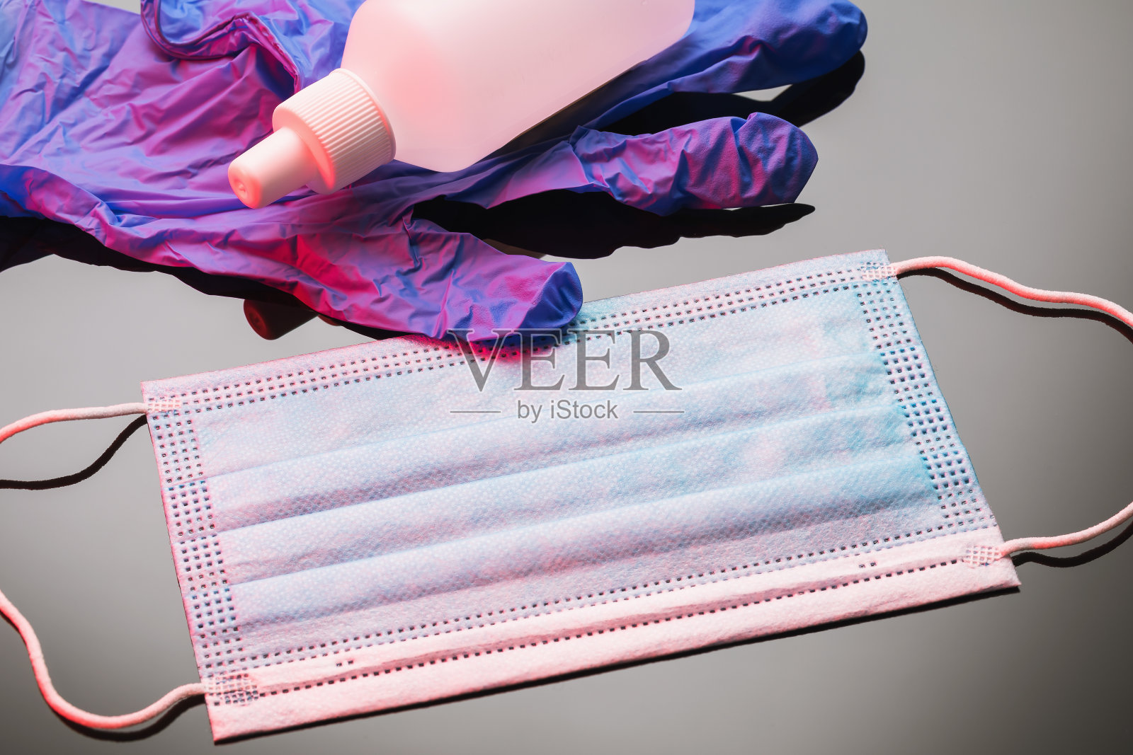 医用口罩、手套和洗手液在渐变背景上照片摄影图片