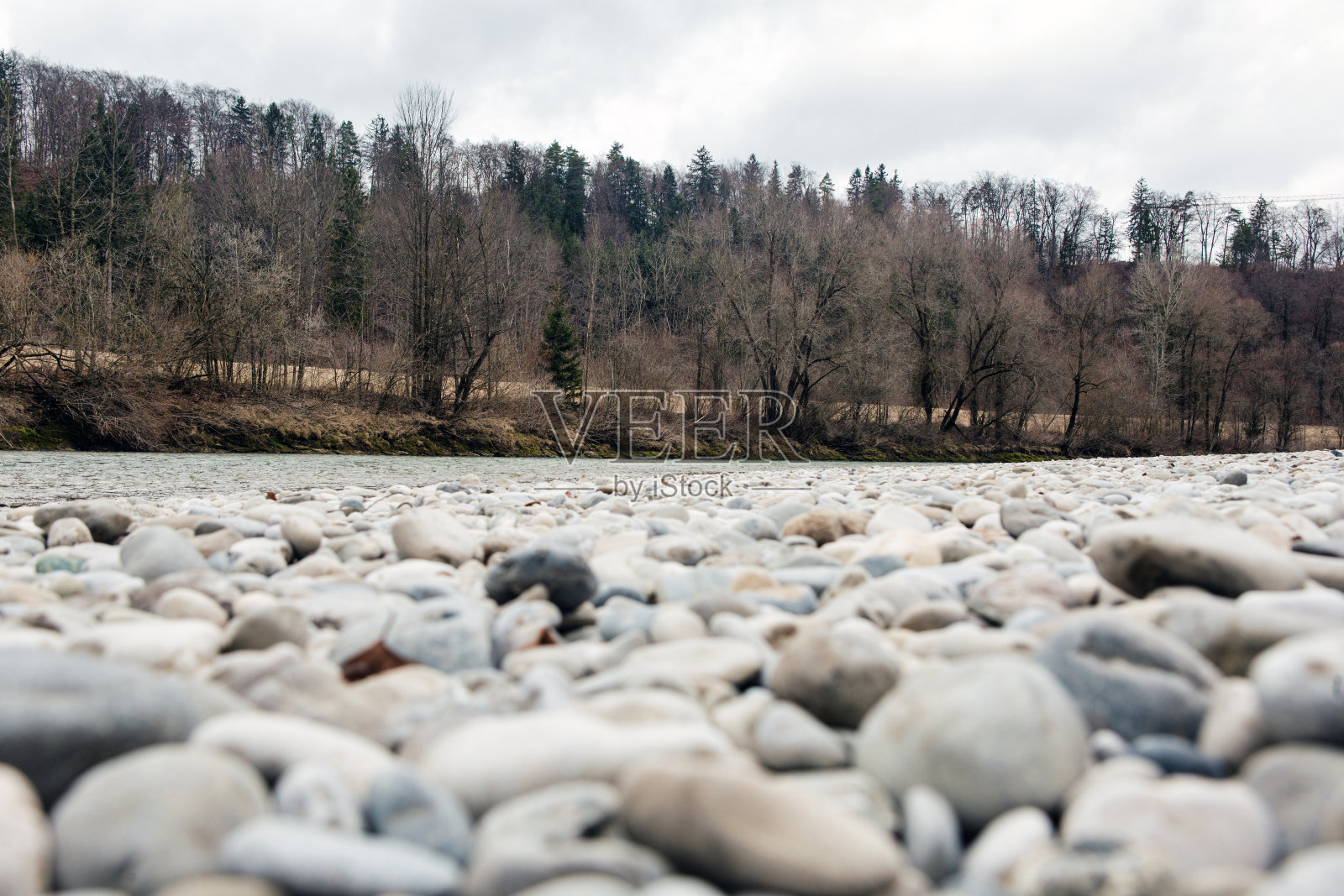 特写的石头和河流与森林在冬天照片摄影图片