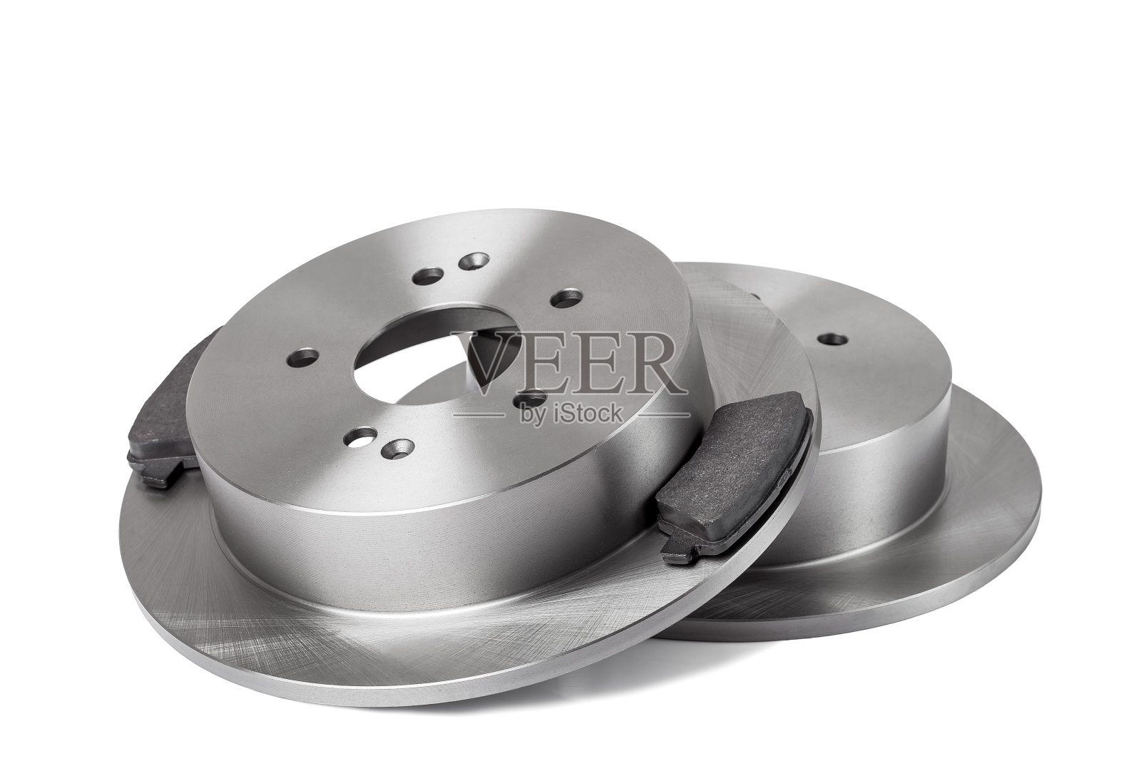 一套新的刹车片和刹车片零配件近距离隔离在白色的背景下，刹车片为一辆新车的状况，没有人。照片摄影图片