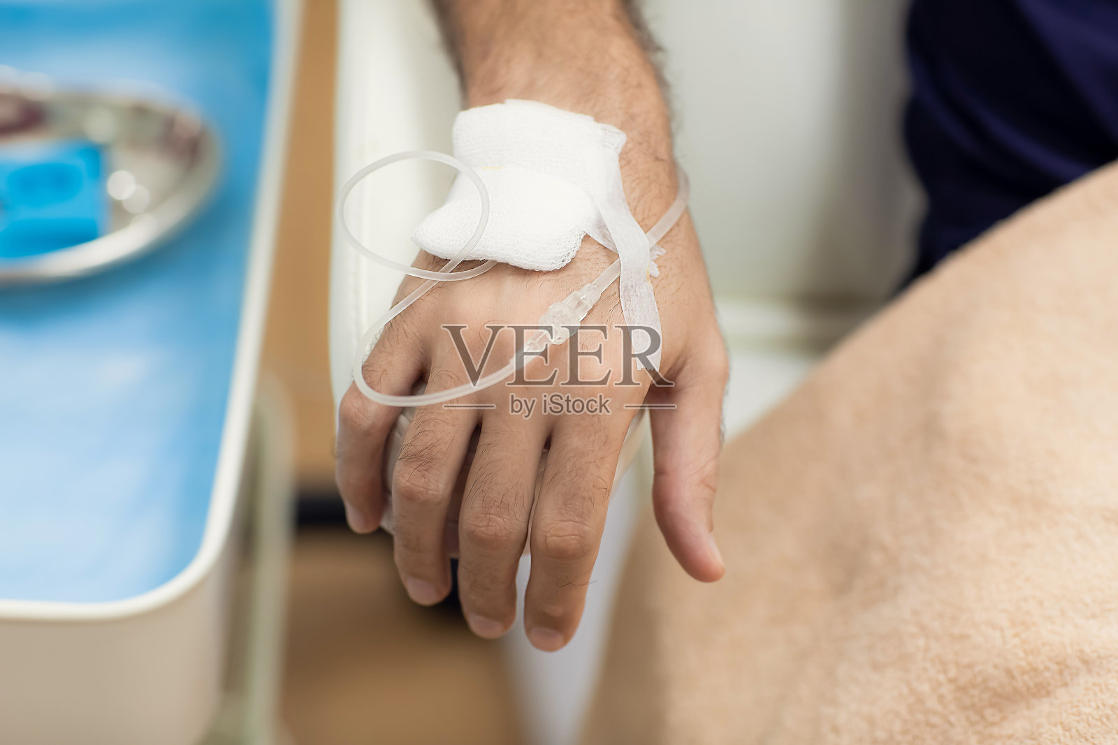 在医院或美容院注射维生素IV的男子的手的特写。保健、健康和医学概念照片摄影图片