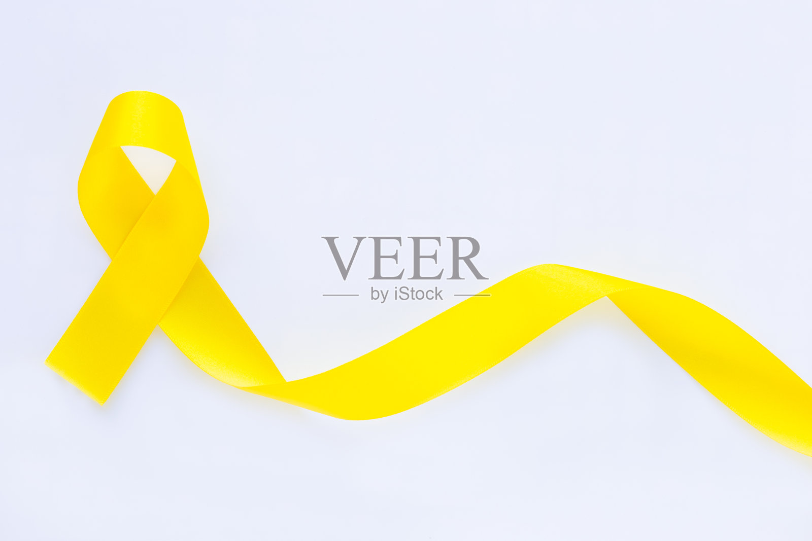 黄色丝带上的白色孤立背景，复制空间。骨癌，肉瘤意识，儿童癌症意识，胆管癌，胆囊癌，世界预防自杀日。健康的概念照片摄影图片