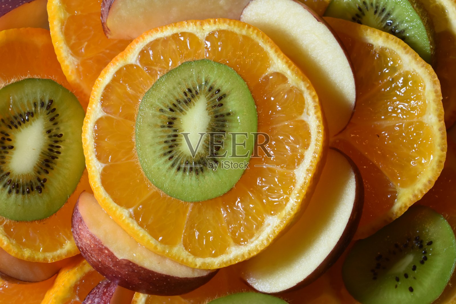 橘子、苹果和猕猴桃片。照片摄影图片