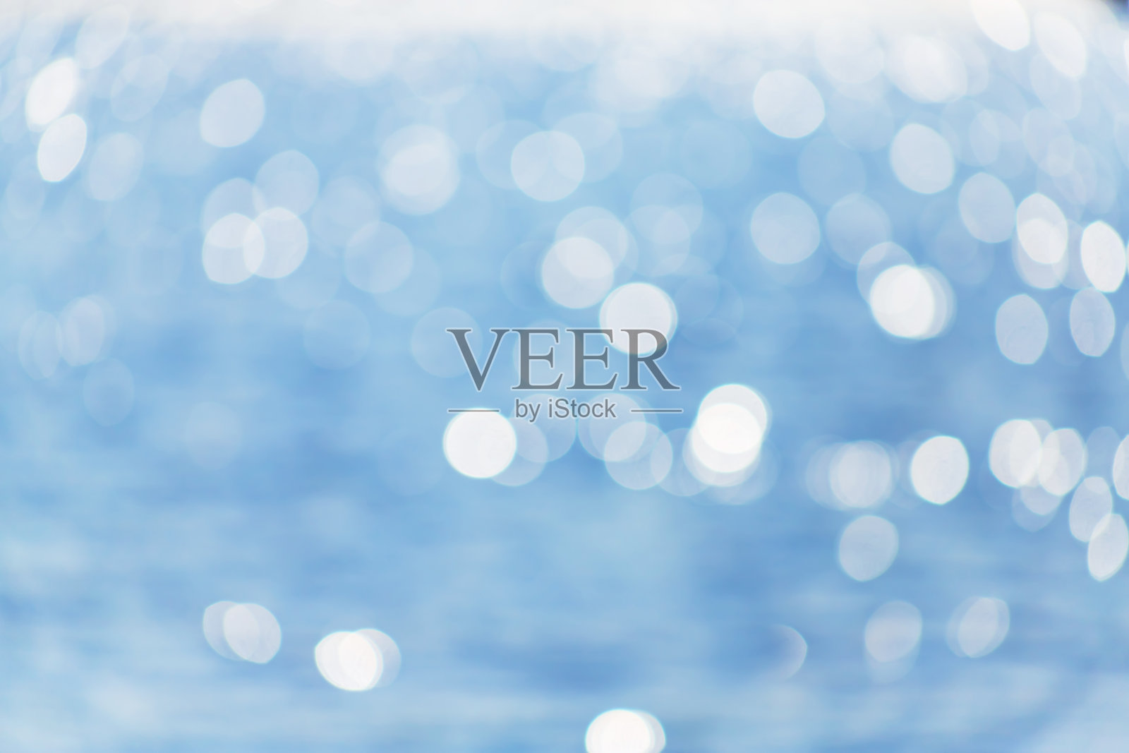 细腻的蓝色纹理散克海。夏天的背景。在阳光明媚的日子里，模糊的蓝色散焦在水面上眩光。旅游概念。照片摄影图片