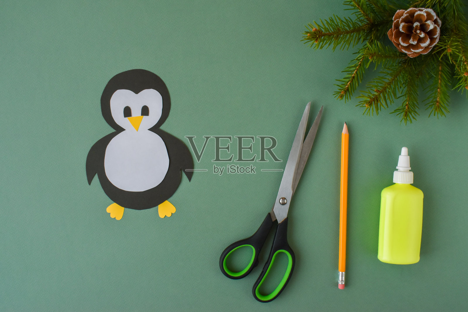 用彩纸做企鹅。一步一步的指示。步骤3。把企鹅身体的各个部分粘起来。企鹅准备好了。照片摄影图片