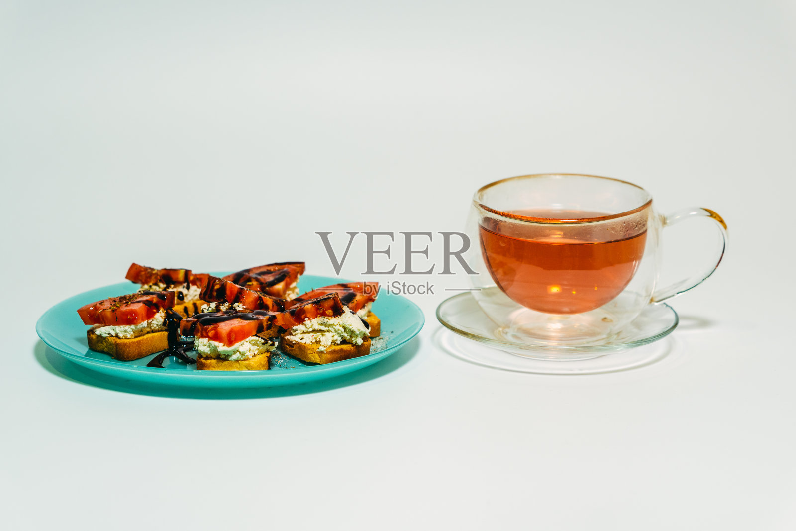 早餐。三明治和茶架放在一个白盘子里。照片摄影图片