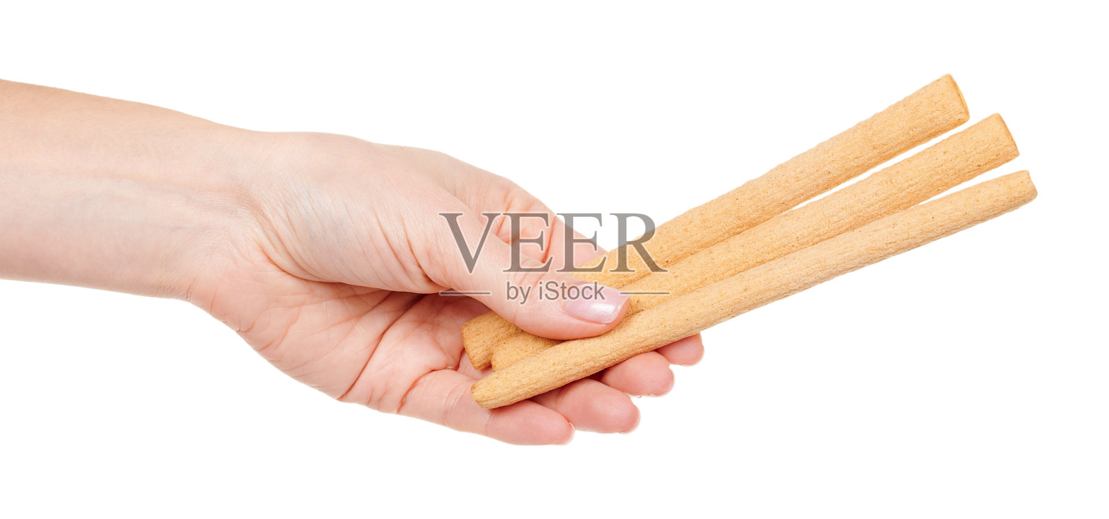 手与饼干棒孤立在白色背景。照片摄影图片