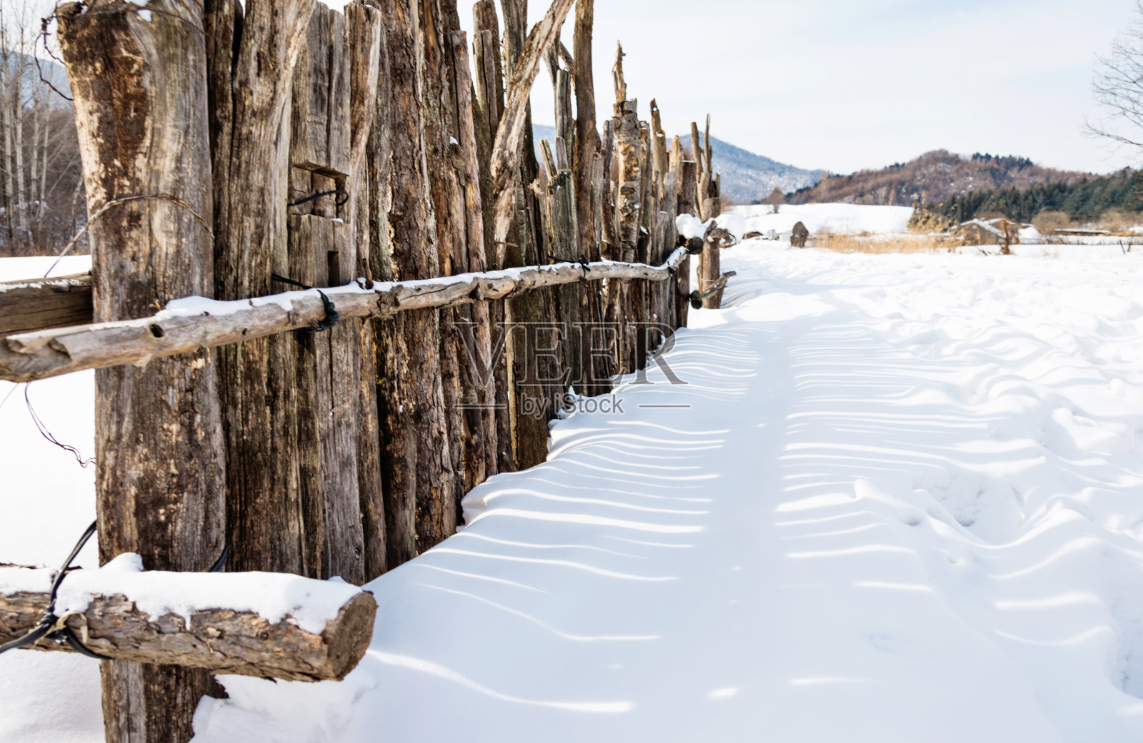 雪地上的木栅栏照片摄影图片
