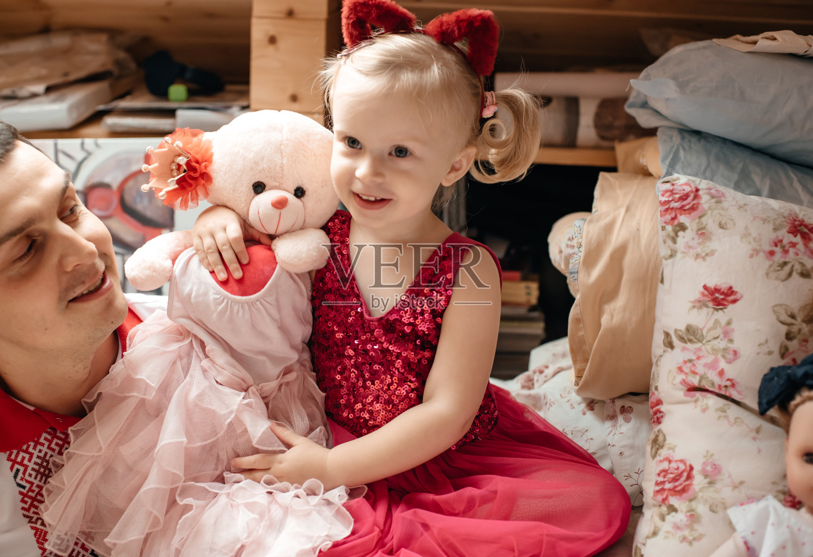 那孩子拿着一个软玩具。照片摄影图片