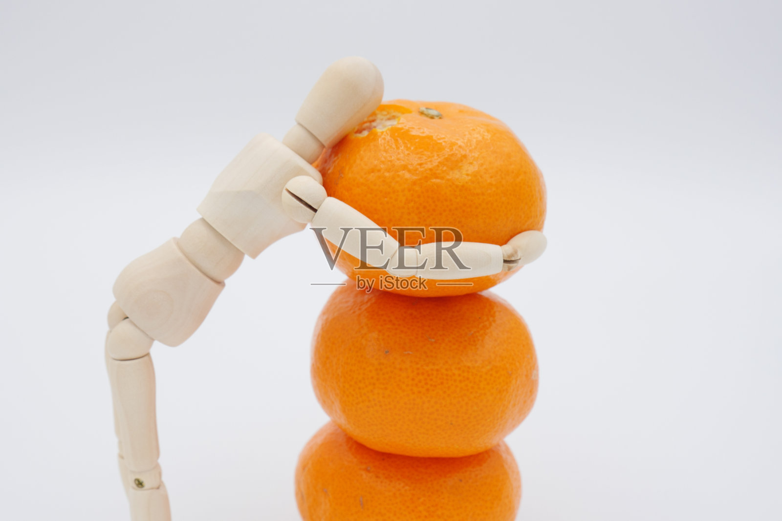 一个会咬一堆橘子的画娃娃照片摄影图片