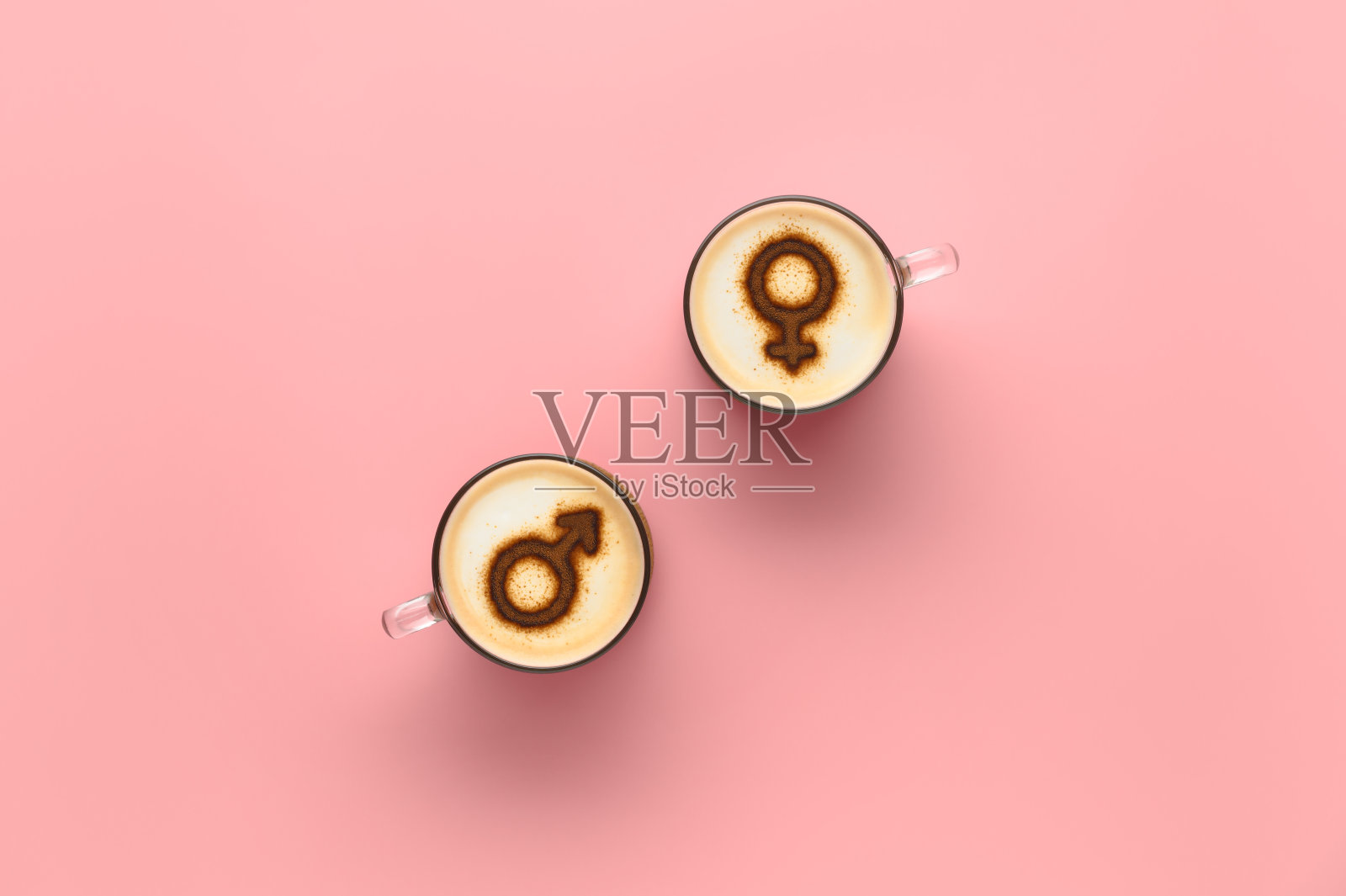 俯视图两杯咖啡与金星和火星的标志上起泡的牛奶泡沫。柔和的粉色背景照片摄影图片