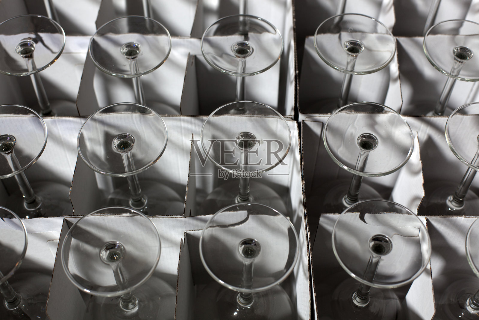 酒杯堆放在一个顶视图的盒子里。照片摄影图片