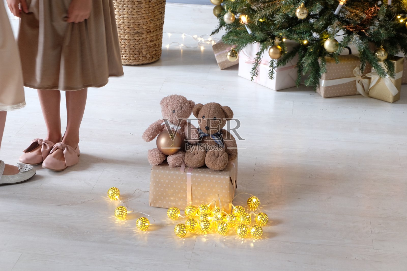圣诞节、新年室内用丝带装饰圣诞礼物，桌子用杯子和棉花糖，圣诞树用白色、银色和粉色的球照片摄影图片