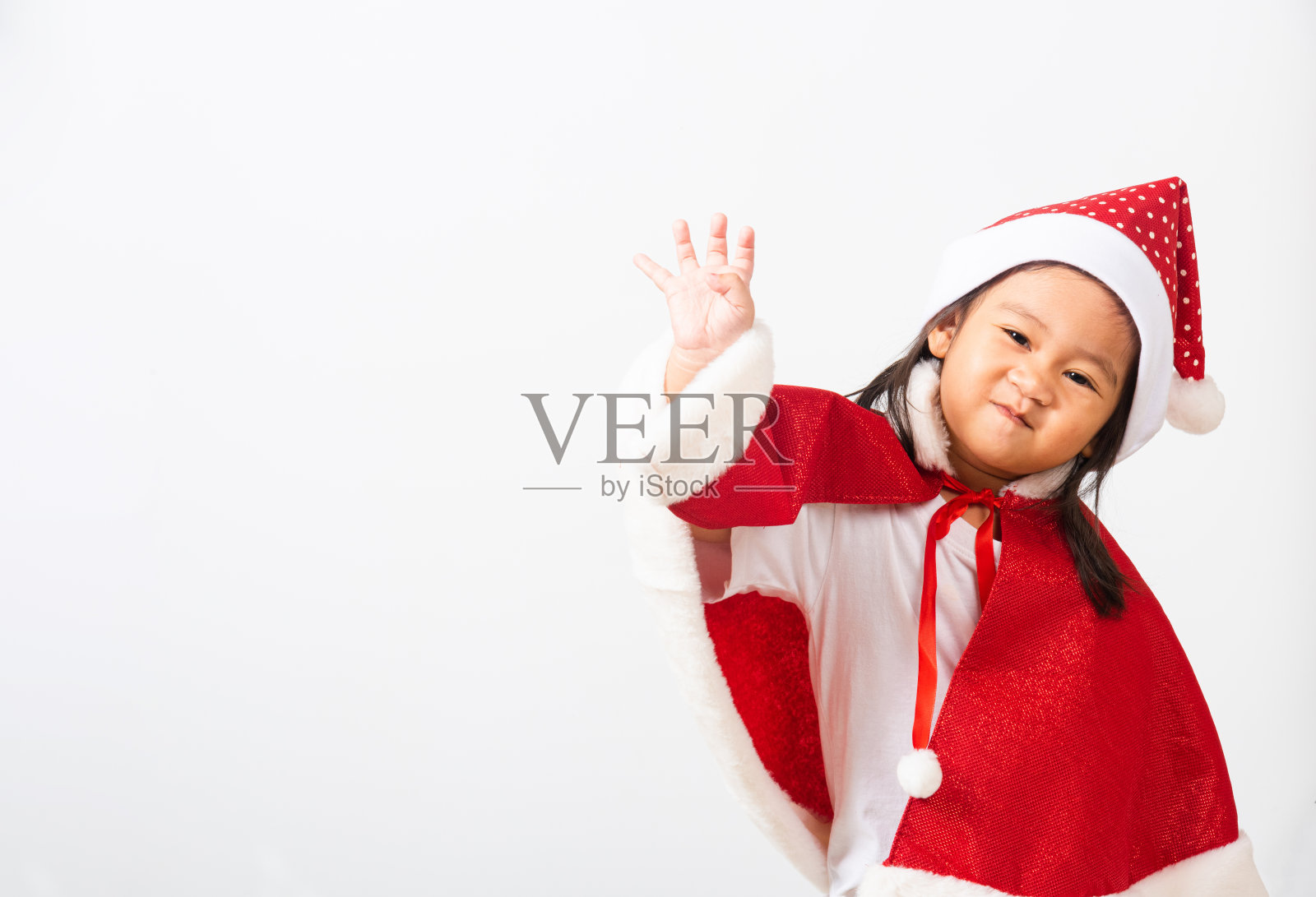 孩子们戴着圣诞老人的帽子过圣诞节的概念照片摄影图片