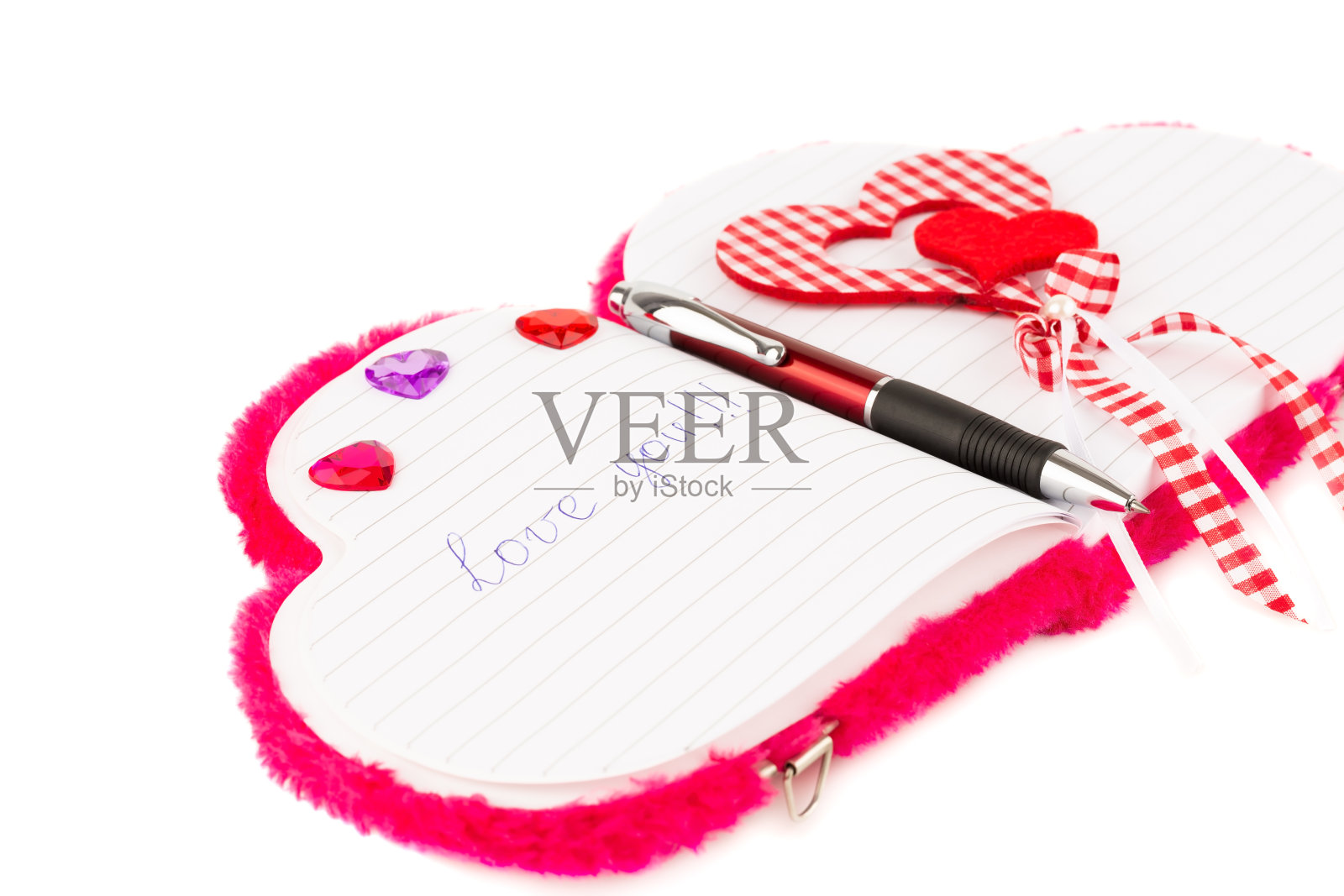 红心，打开记事本上的笔照片摄影图片