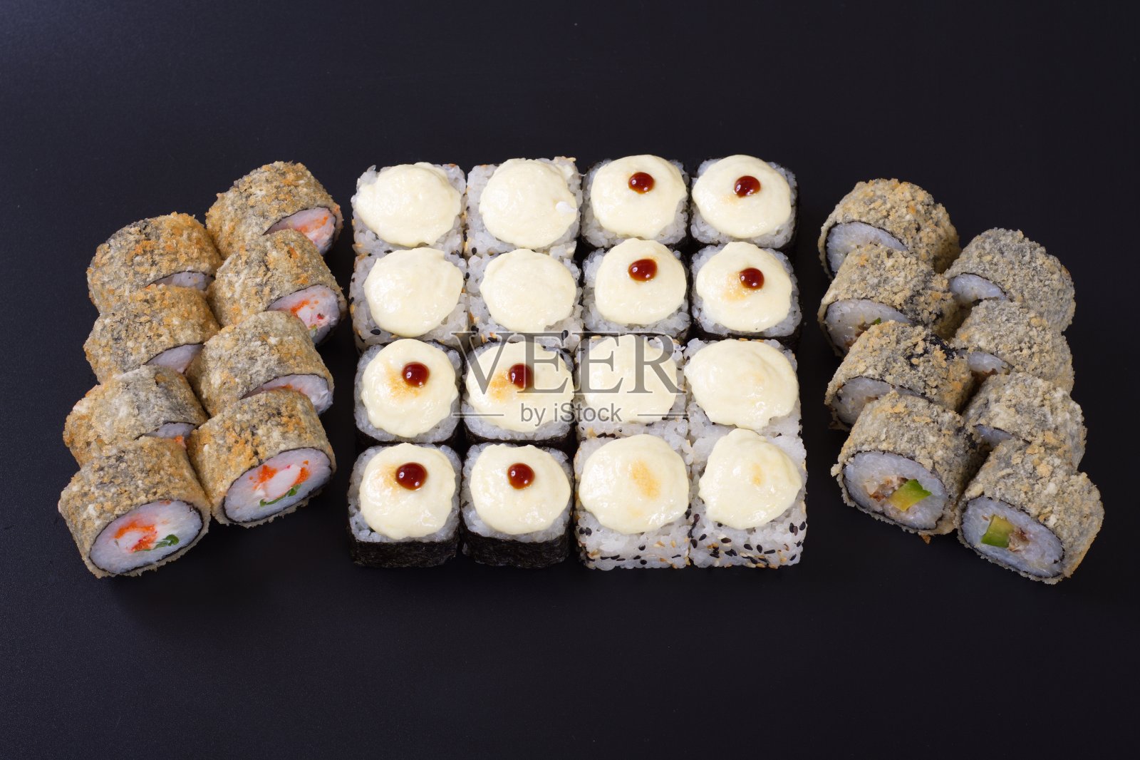 深色的石头背景上是五颜六色的海鲜卷和米饭照片摄影图片