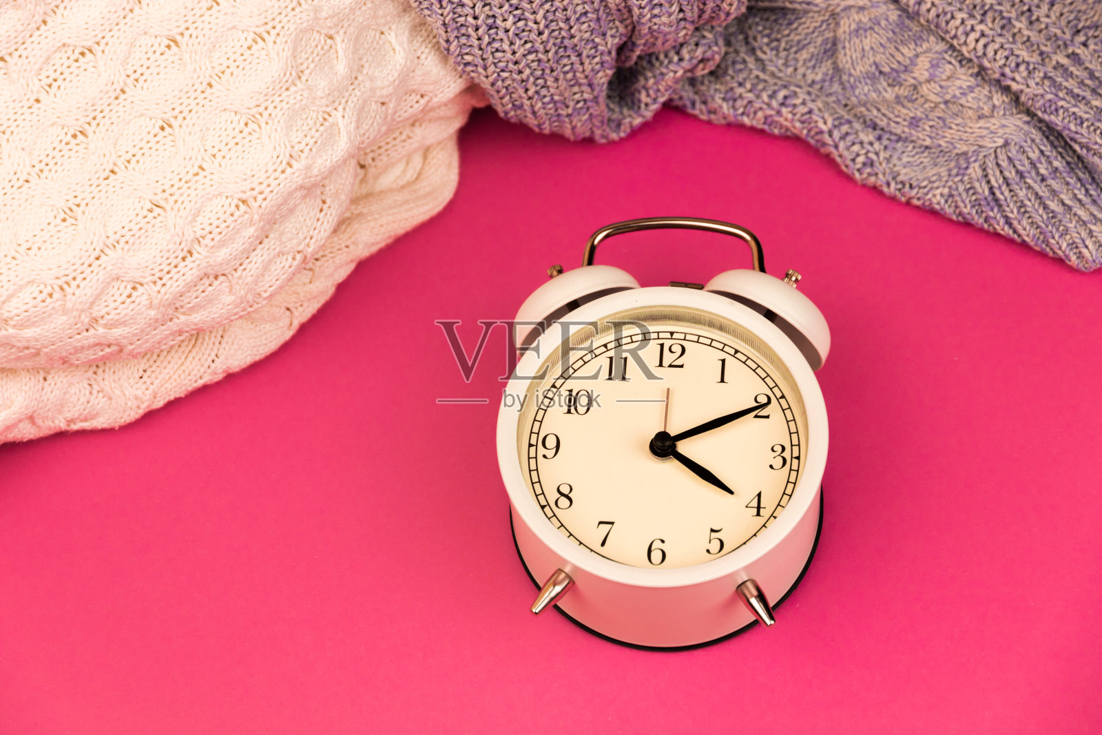 老式闹钟背景上的蜡笔简单的背景，复制空间和针织毛衣照片摄影图片