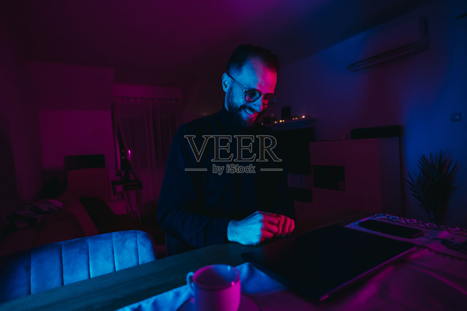 晚上在家办公用笔记本电脑工作的男人照片摄影图片