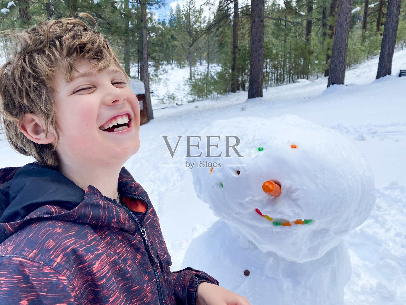 顽皮的孩子和他顽皮的雪人照片摄影图片
