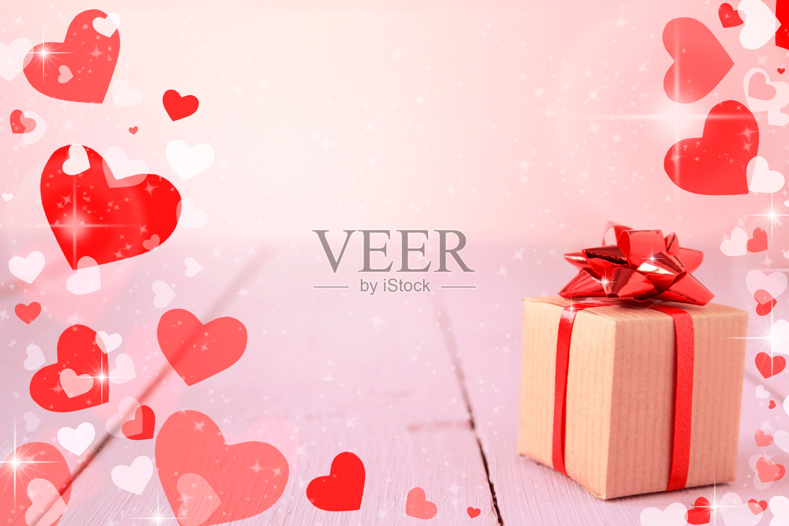 礼盒上的粉红色背景与散景灯和红心框架。情人节背景，贺卡和横幅，拷贝空间，选择性焦点照片摄影图片