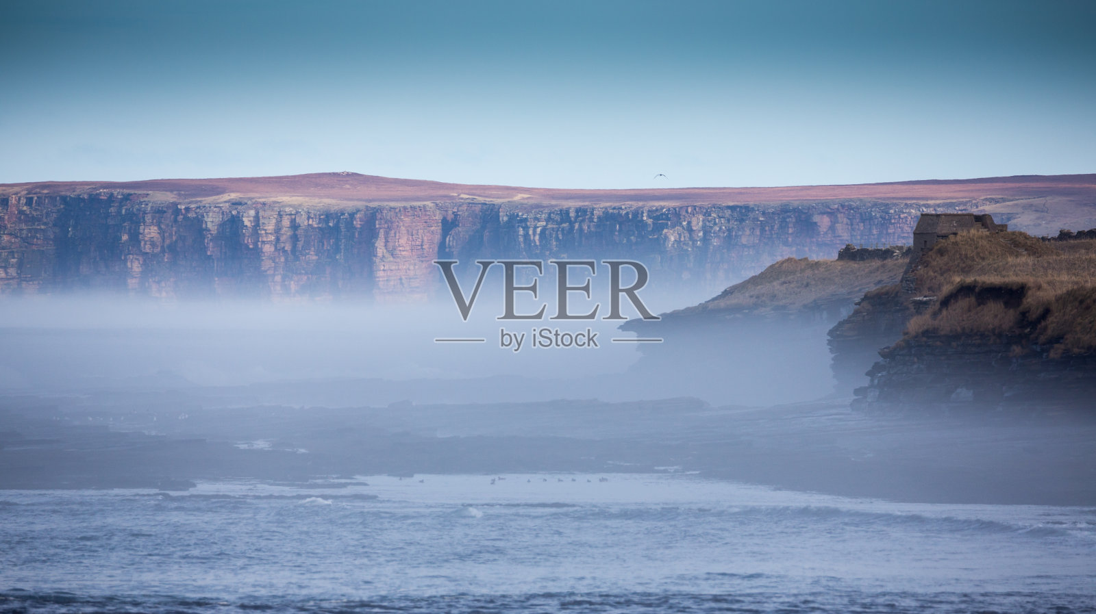 悬崖边雾蒙蒙的海景照片摄影图片