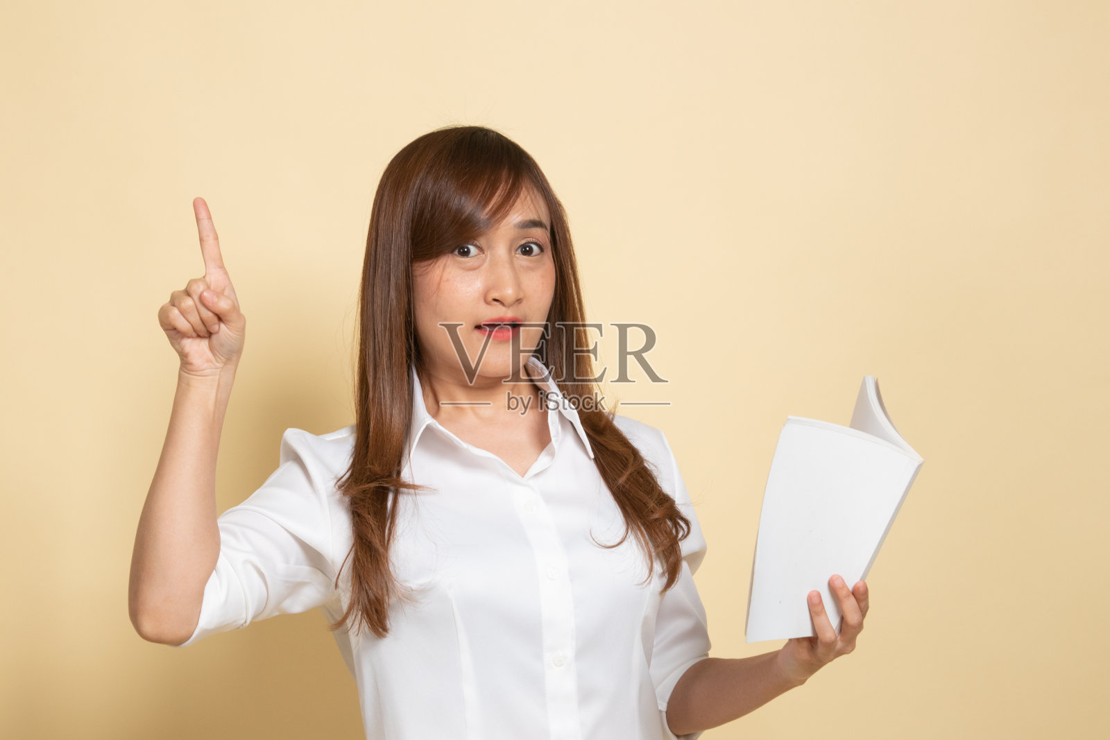 年轻的亚洲女人有一本书有一个想法。照片摄影图片