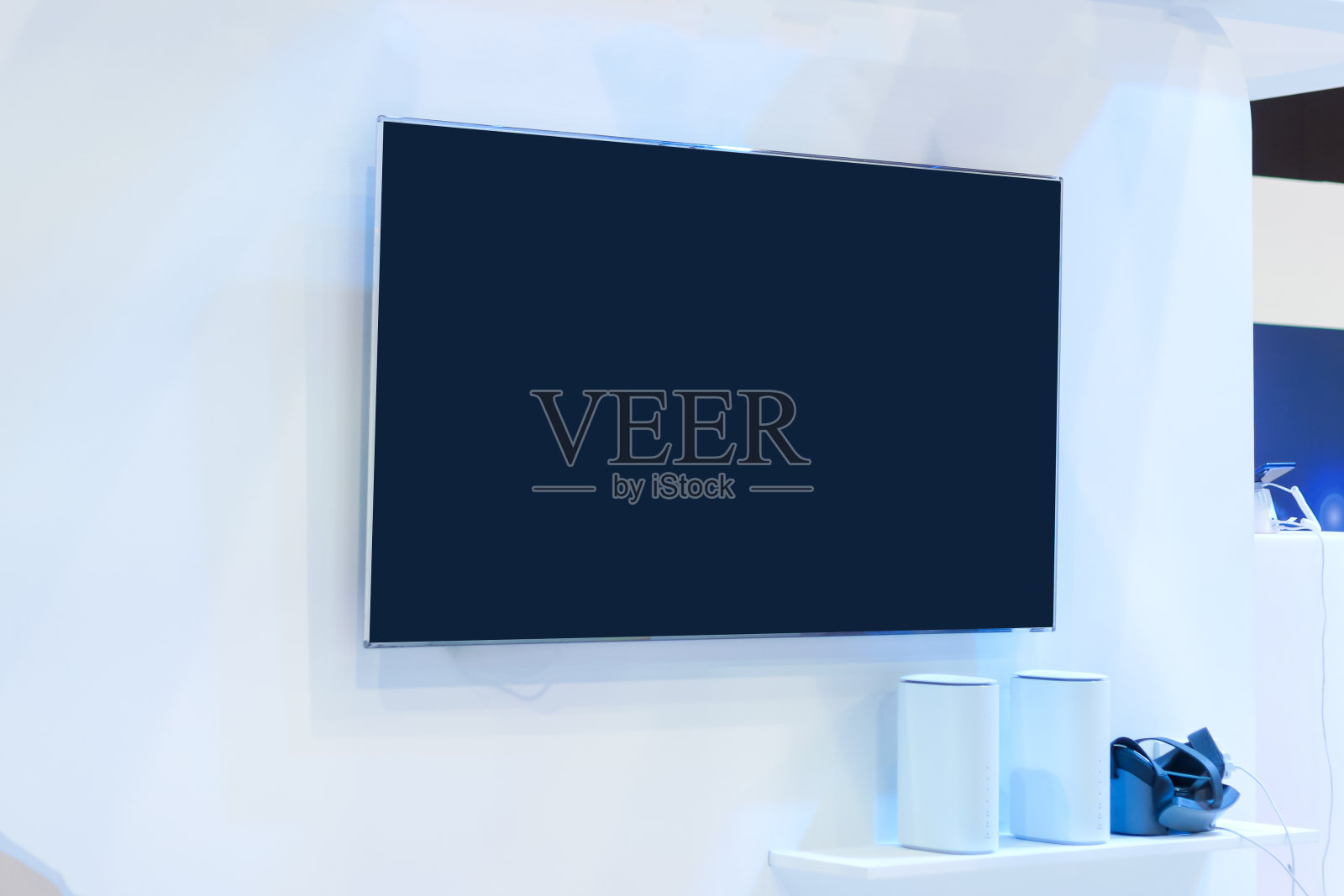 空白液晶智能电视在会议展览、贸易展览和会议厅展位展示，白色模拟空白广告在蓝色背景照片摄影图片