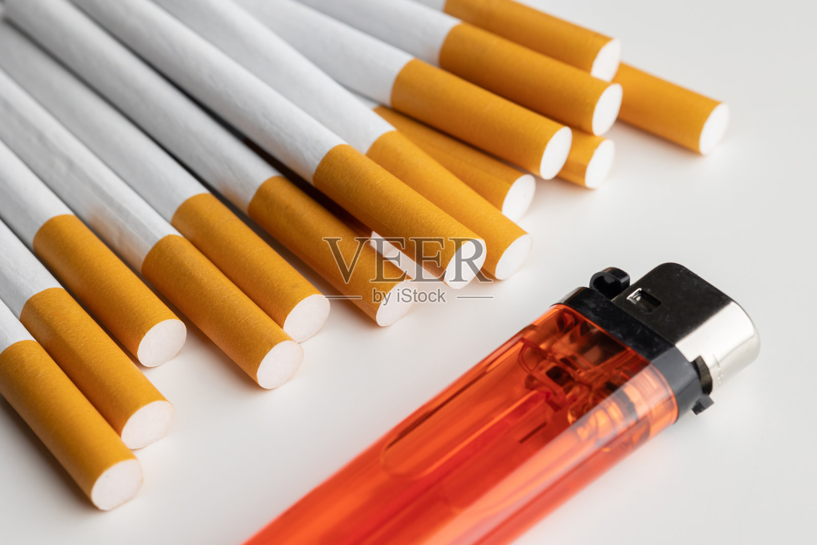 许多香烟和打火机堆放在一起。药物对呼吸系统有害。照片摄影图片