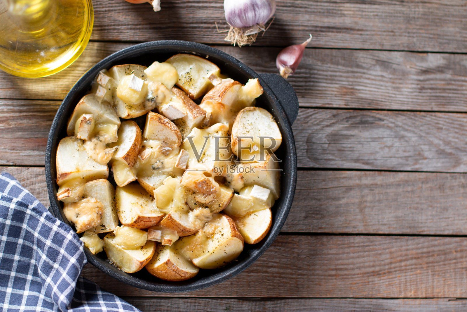 在烤箱里烤土豆和奶酪。前视图。副本的空间。照片摄影图片