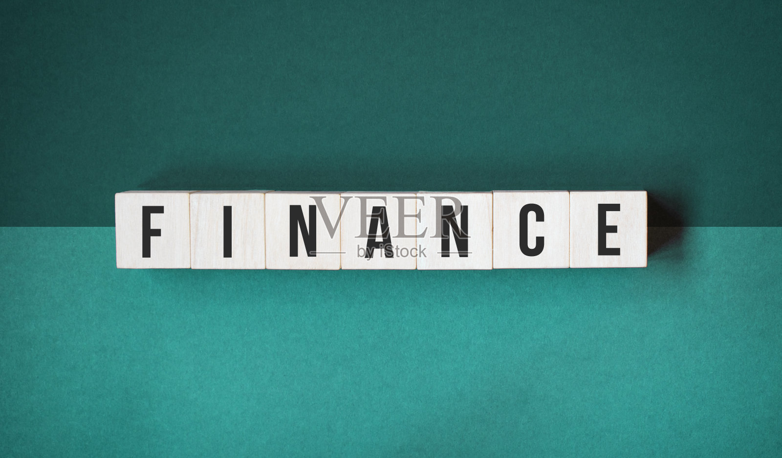 关于木立方体的金融词汇。投资和储蓄的概念。橙色背景上孤立的字母木块。照片摄影图片