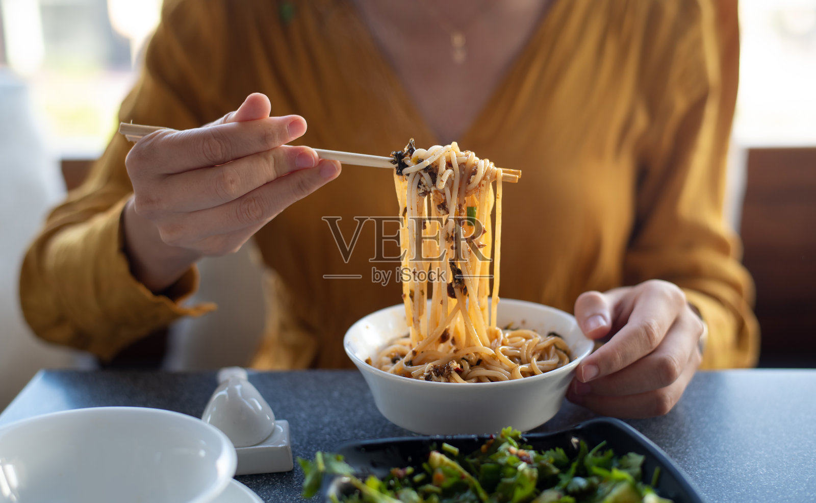 人物在餐厅里吃面条特写照片摄影图片