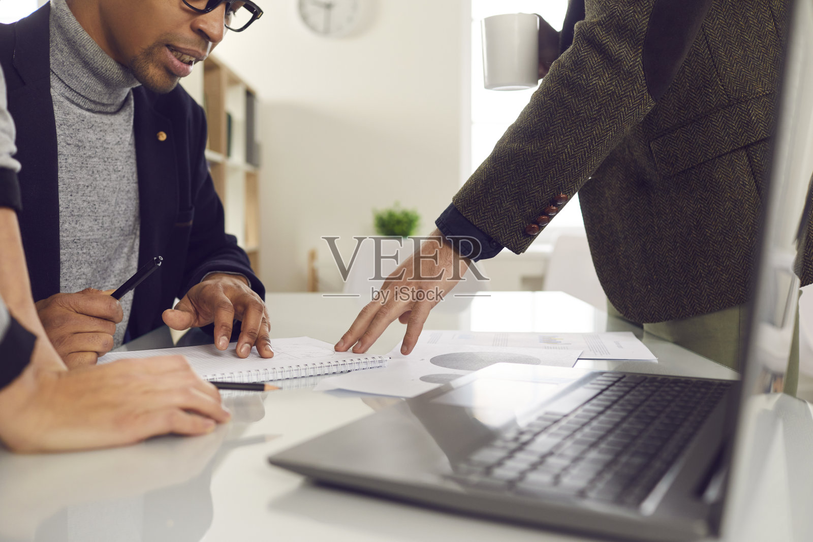 不同的项目小组围绕办公桌旁开会，共同完成项目照片摄影图片