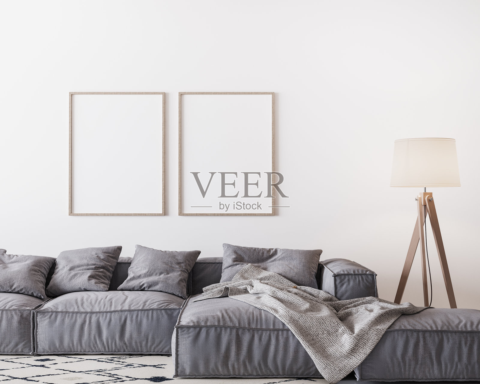 家庭内部模型与灰色沙发和木地板灯在明亮的客厅，两个木制框架模型上的白色墙壁照片摄影图片