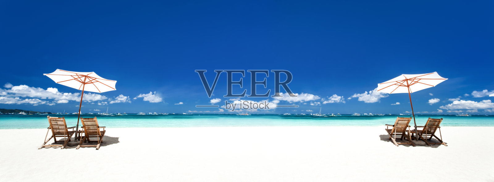 热带海滩上的太阳伞和木床。加勒比海热带海岸度假照片摄影图片