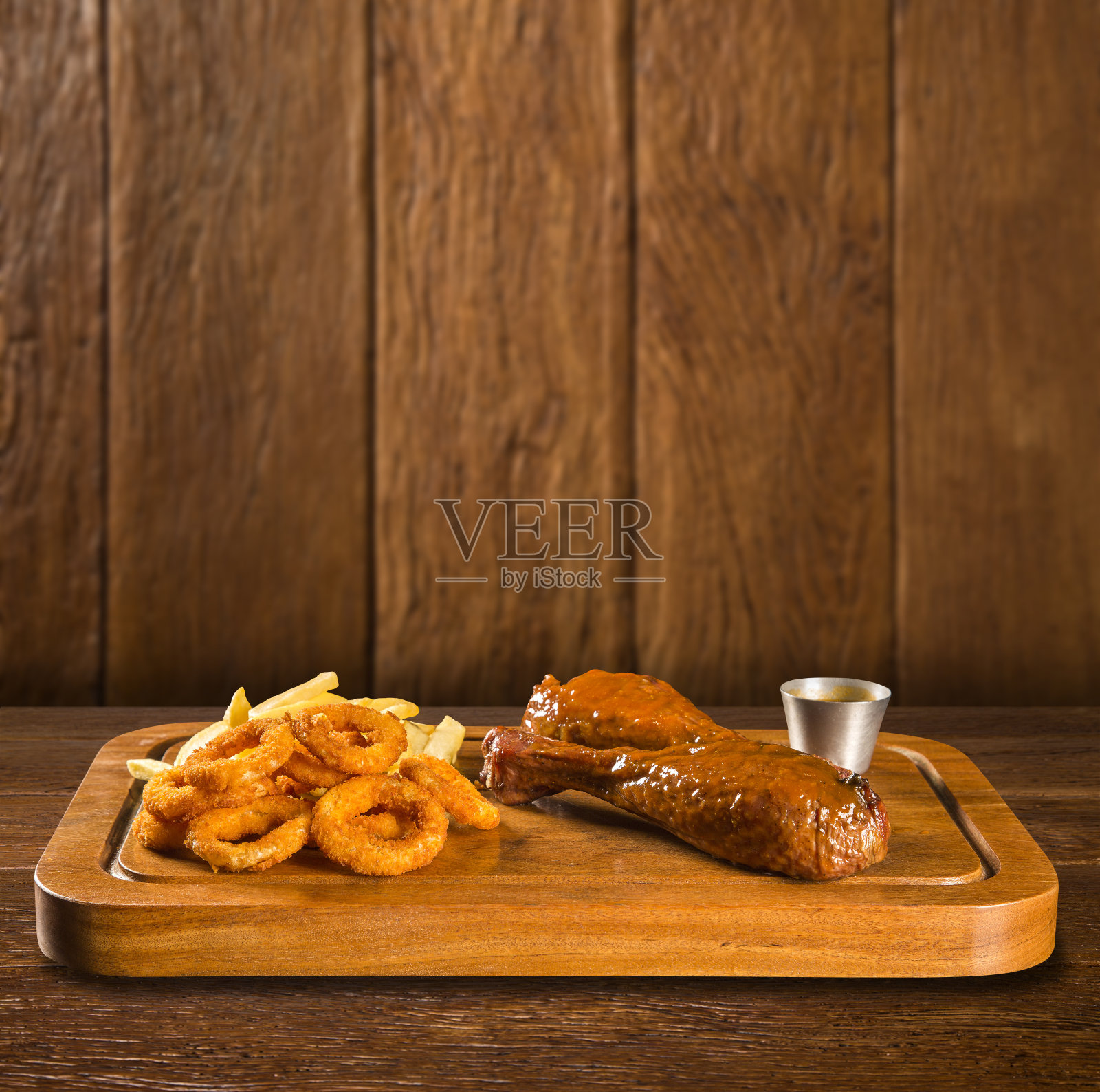 鸭腿配薯条和洋葱圈照片摄影图片