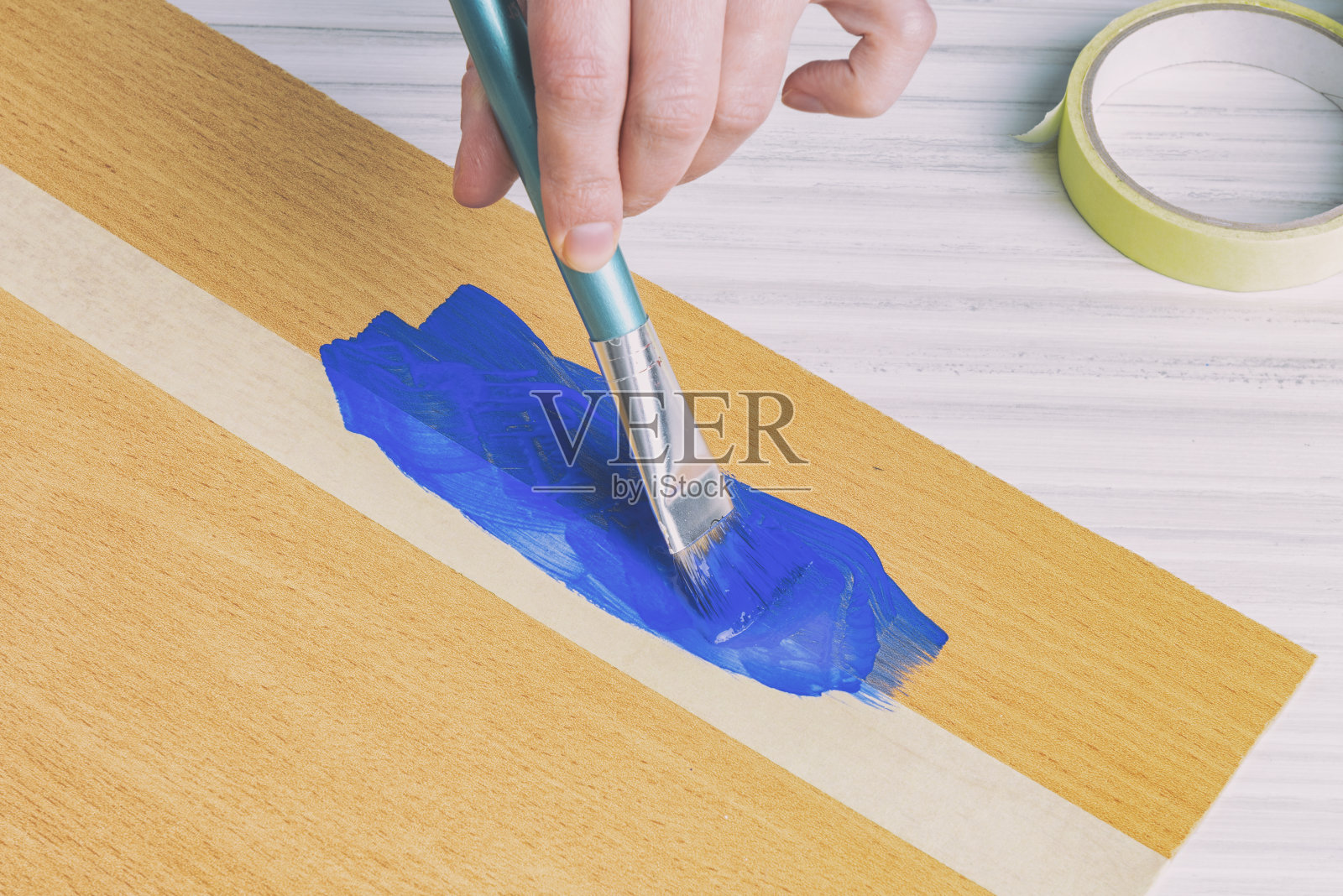 使用遮蔽胶带时，用画笔照片摄影图片