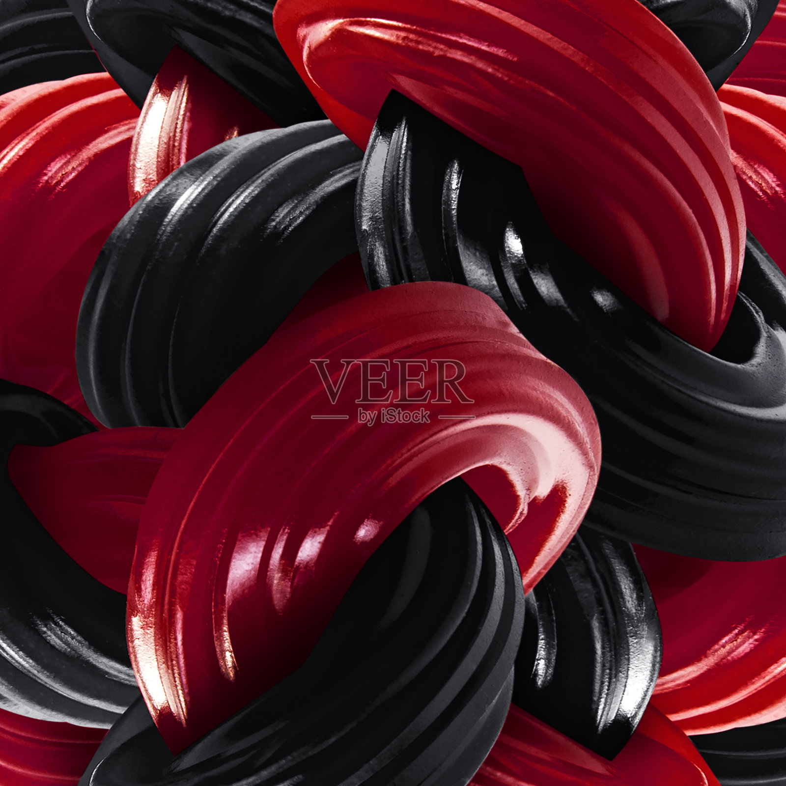 近距离打结的软草莓和黑甘草糖棒照片摄影图片