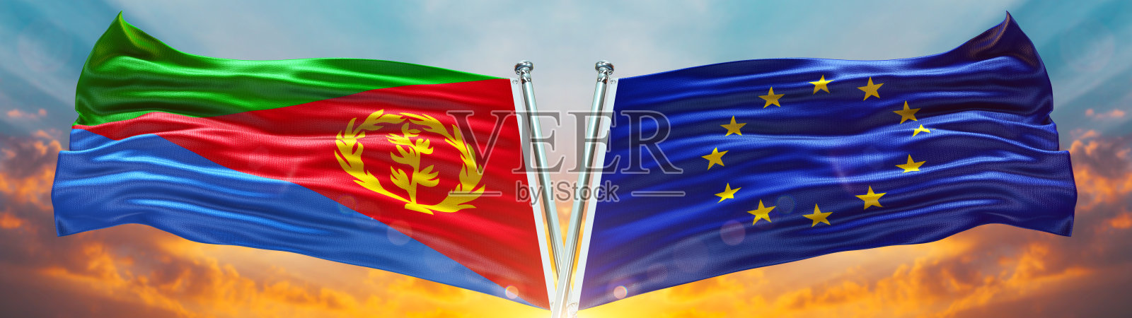 欧盟国旗和厄立特里亚国旗在天空中飘扬，天空中有云朵和夕阳的光线照片摄影图片
