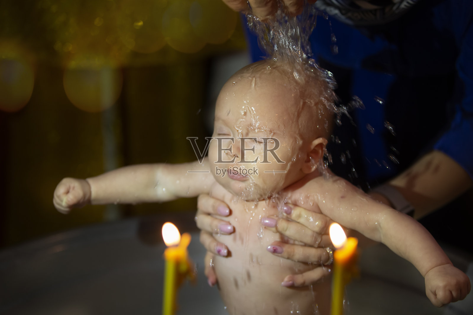 一个孩子的正统洗礼。教会接受信仰的仪式。这孩子受洗了。照片摄影图片