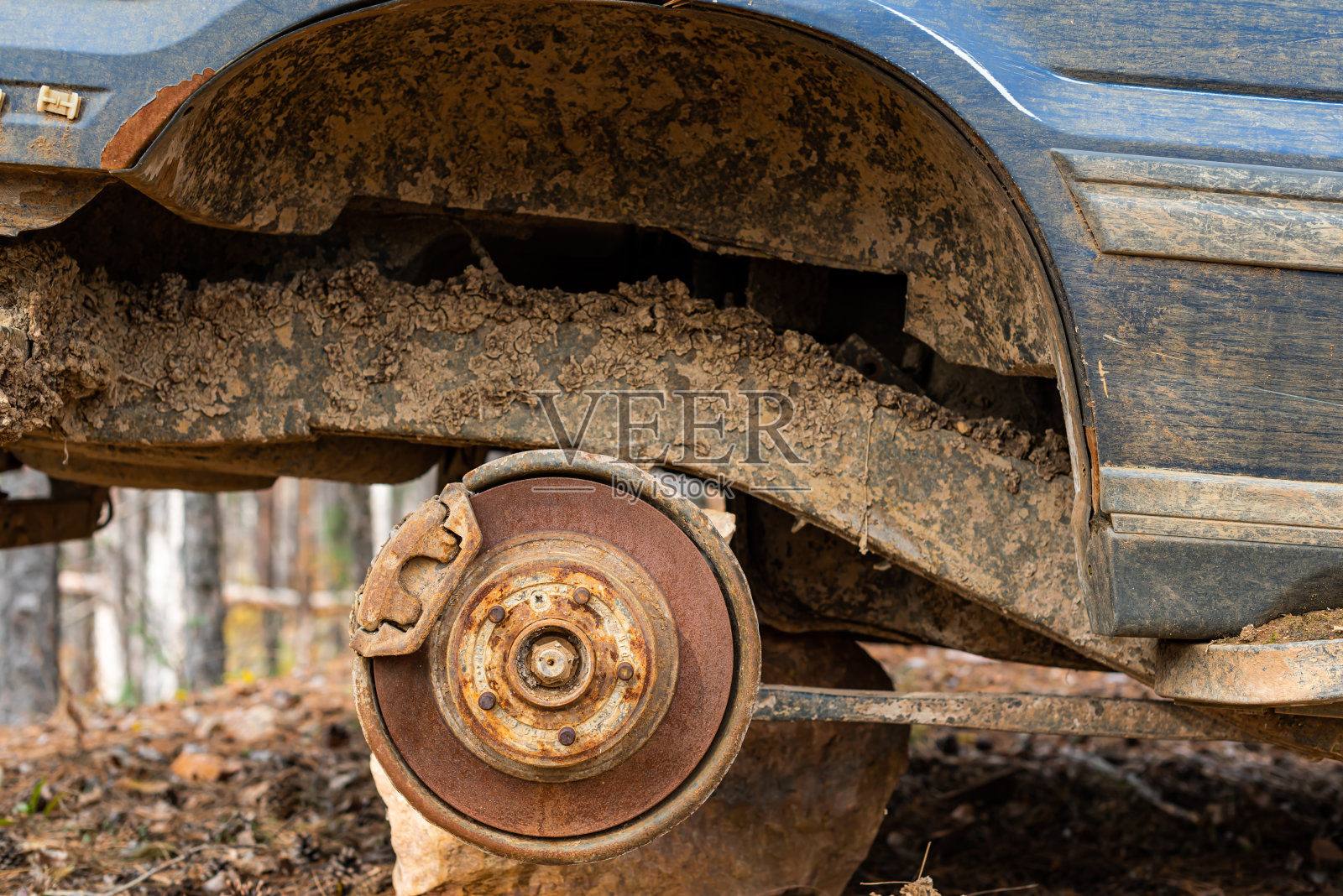 近距离的汽车丢失车轮被盗车轮污染和犯罪问题对话古董生锈的细节丢弃在秋天的森林在保加利亚，东欧照片摄影图片