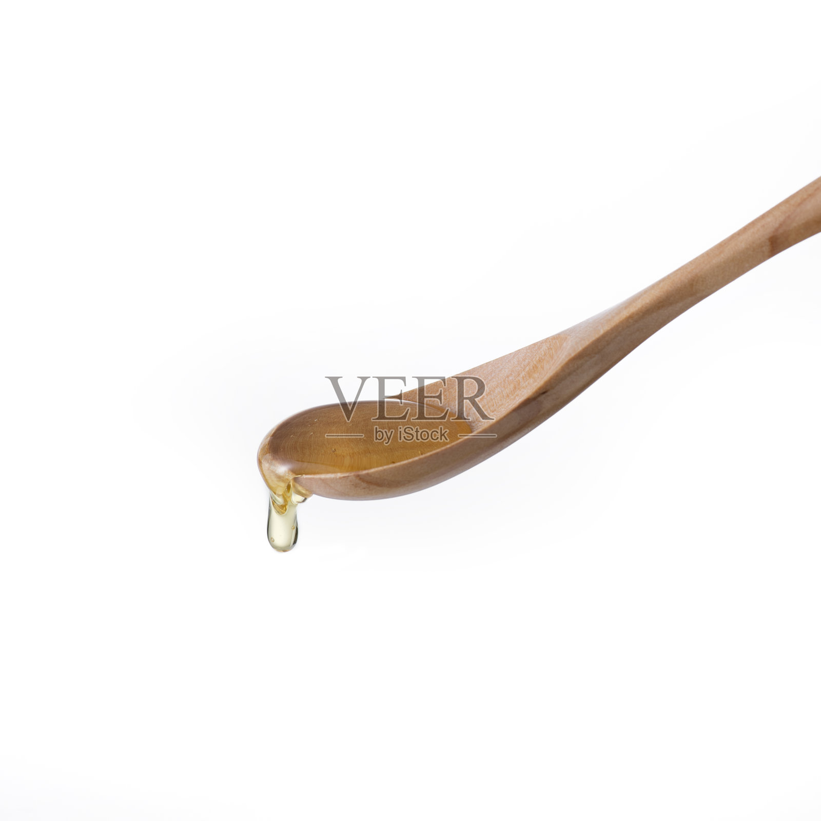 蜂蜜从勺子里滴下来照片摄影图片