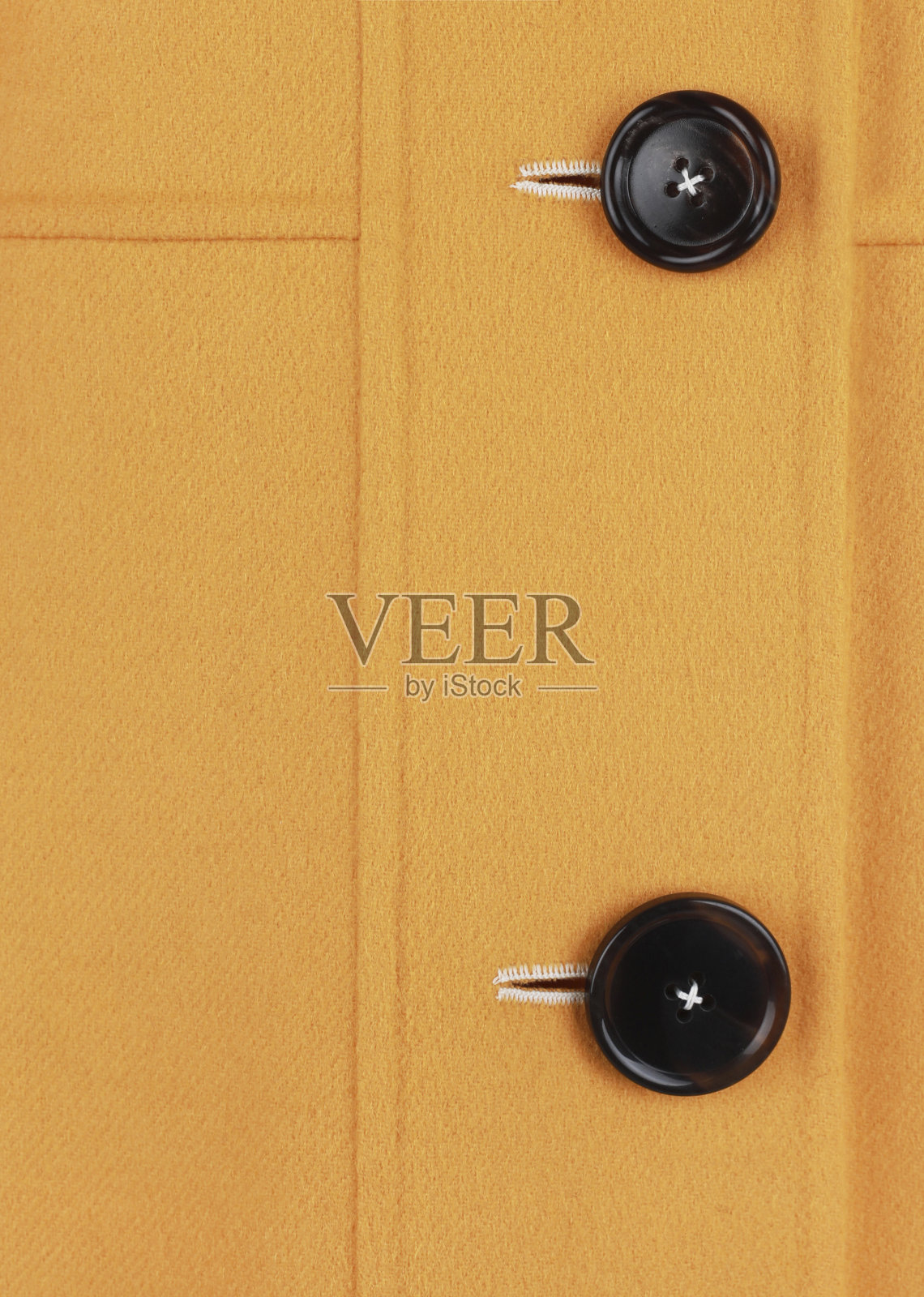 黄色外套的一部分，钮扣靠近照片摄影图片