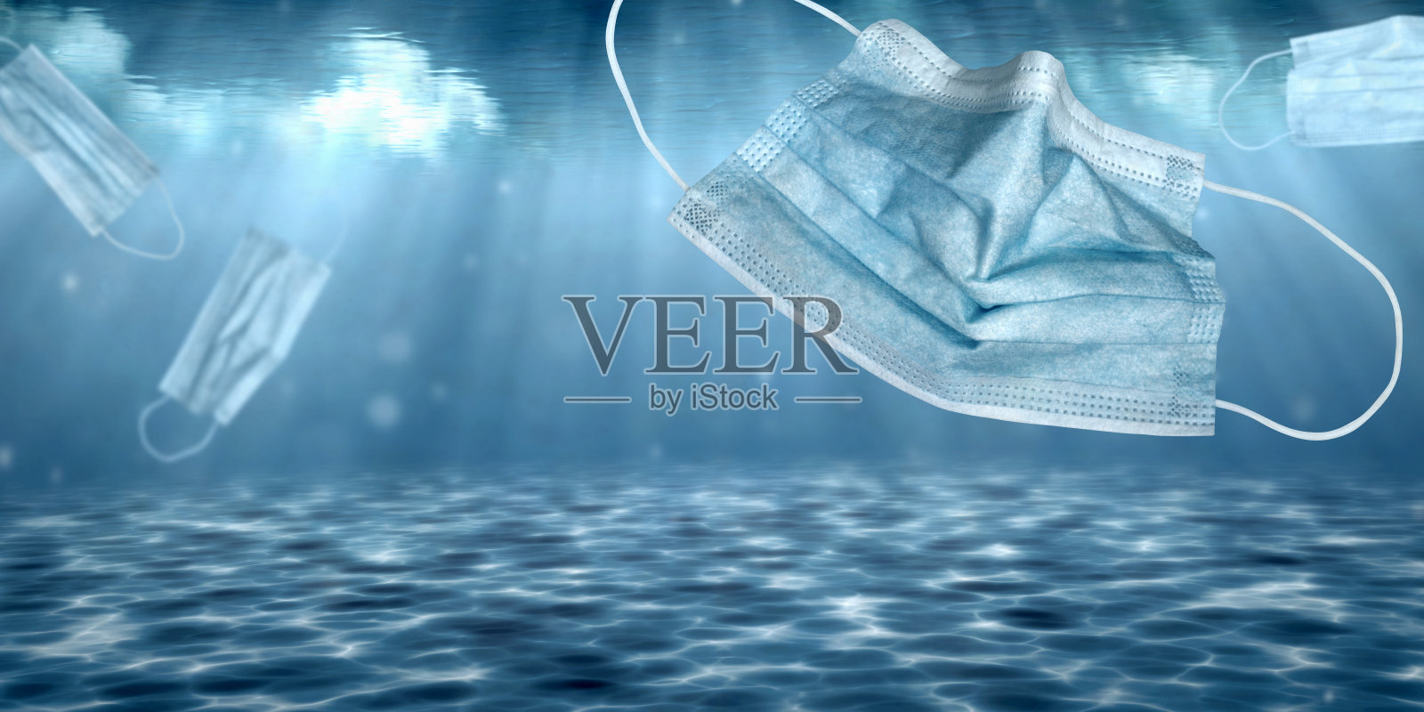 戴着医用口罩沉入水下和污染环境照片摄影图片