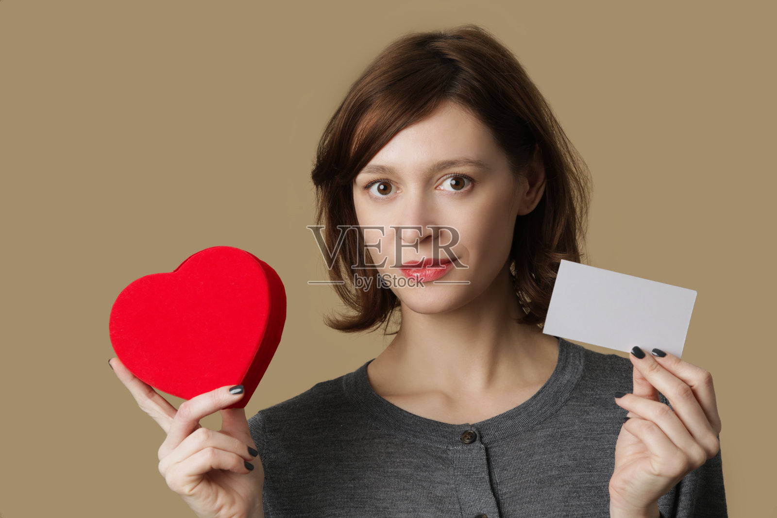 年轻女子的肖像与红心形状的礼盒和空白纸便条。幸福，情人节和爱情的概念。照片摄影图片