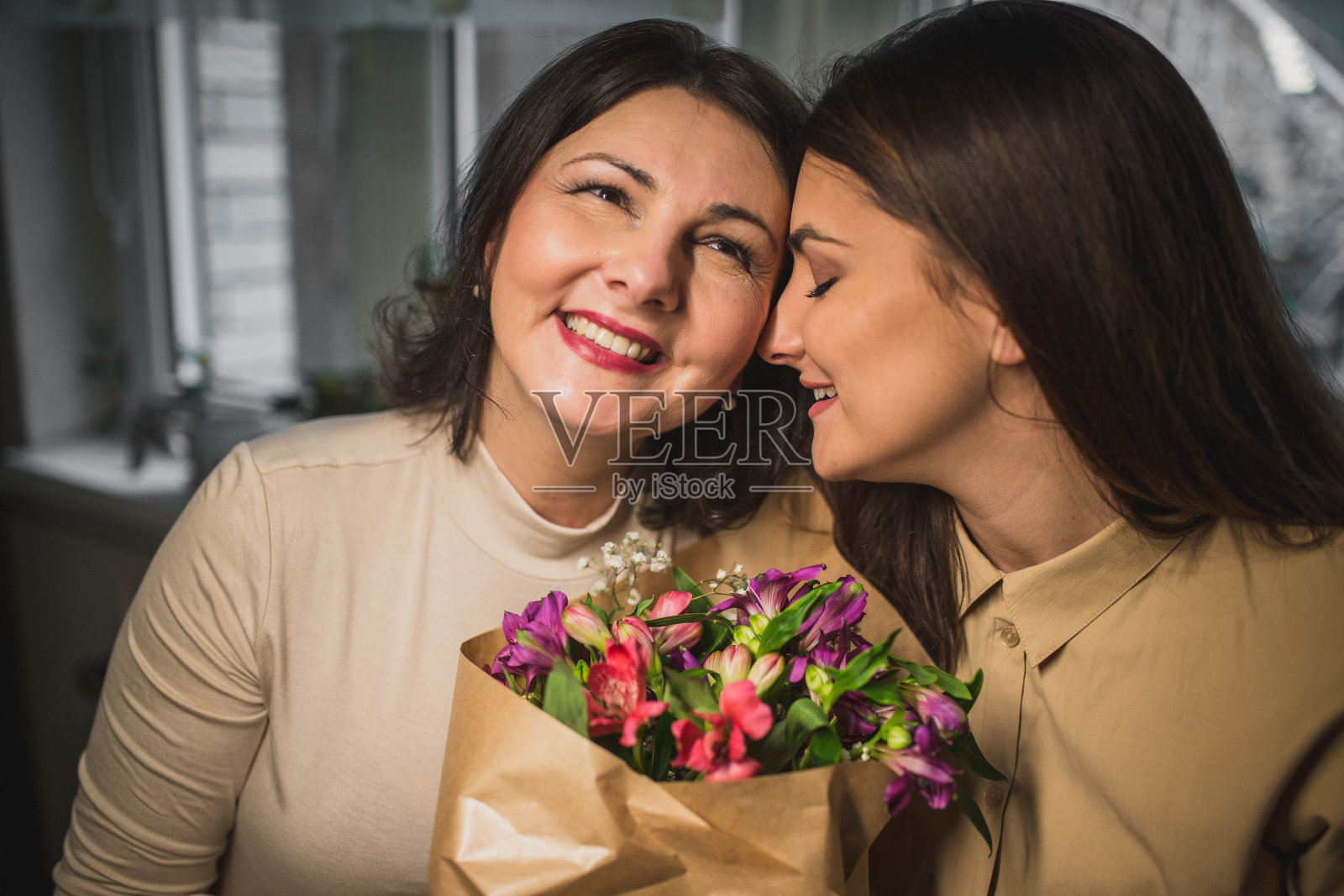 国际妇女节，一幅幸福母女的画像，手捧一束鲜花照片摄影图片