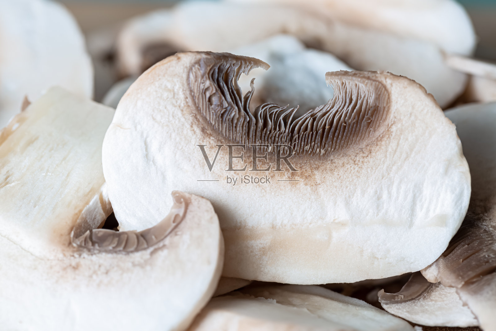 白色蘑菇切成两半。景深浅照片摄影图片