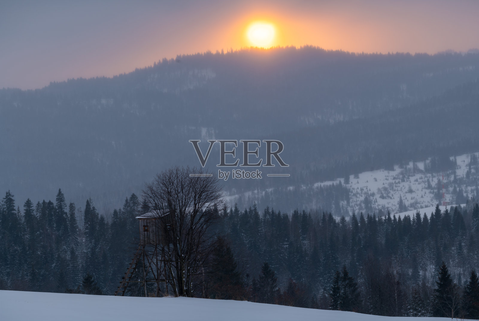 狩猎塔在冬季日出时的山景照片摄影图片