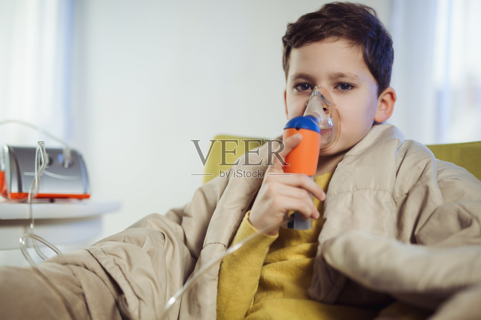 患有哮喘的男孩戴着口罩吸入空气照片摄影图片