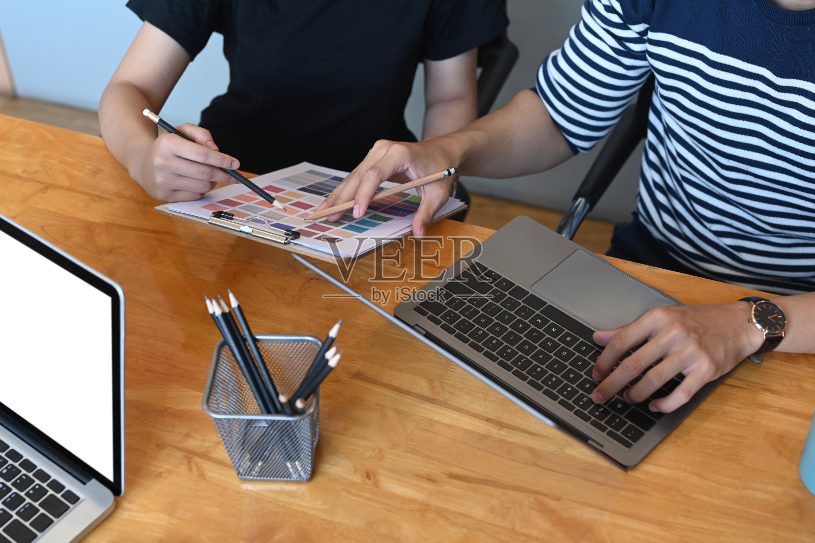 两个年轻的创业者在现代办公室讨论一些文书工作的镜头。照片摄影图片