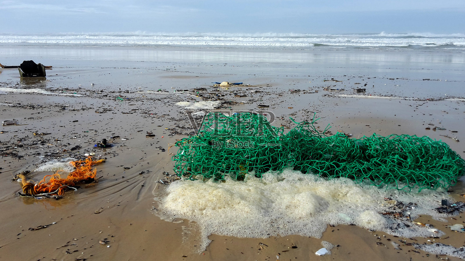 风暴潮过后，塑料垃圾被冲上了海滩照片摄影图片
